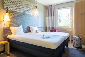Letto o letti in una camera di ibis Baden Neuenhof