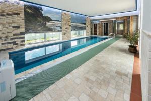 a swimming pool in the middle of a house at Melnmuižė in Karklė