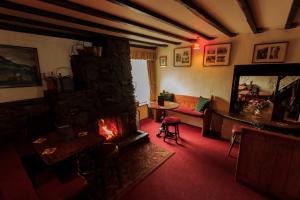 a living room with a fireplace and a couch at Kirkstile Inn in Loweswater