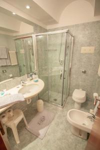 a bathroom with a shower and a sink and a toilet at Hotel Terme Orvieto in Abano Terme