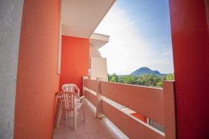 a balcony with two chairs and a view at Hotel Terme Orvieto in Abano Terme