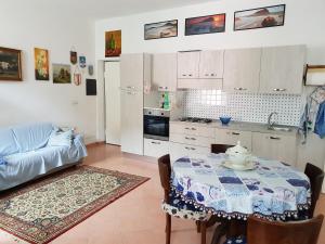 a kitchen and dining room with a table and a couch at lake house in Mezzanego