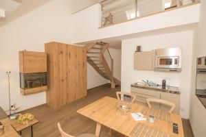 a kitchen and dining room with a wooden table and chairs at MeerBlickD21 Residenzen in Norderney