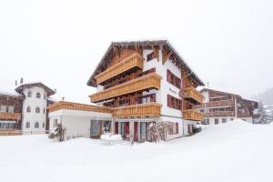 a large building in the snow with snow at Haus Miranda Grächen in Grächen