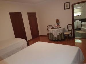 a bedroom with a table and a bed and a table and chair at Casa Das Aguas Ferreas in Estação do Mogadouro