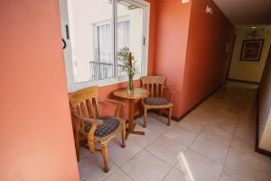 a room with a table and two chairs and a window at Pousada Raio de Sol in Jaguarão