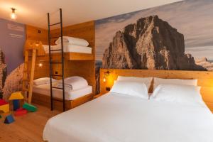 a bedroom with two bunk beds and a mountain mural at Rifugio La Montanara in Molveno