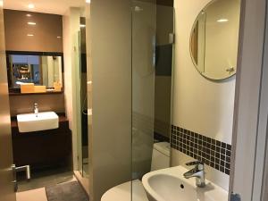 a bathroom with a sink and a glass shower at Everyday Sukhumvit 11-13 Asok Nana Nightlife in Bangkok +13 photos