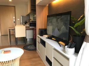 a living room with a flat screen tv on a entertainment center at Everyday Sukhumvit 11-13 Asok Nana Nightlife in Bangkok