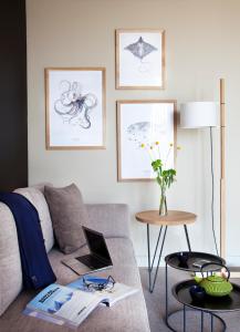 a living room with a couch and a table with a laptop at Hotel Arima & Spa - Small Luxury Hotels in Donostia-San Sebastián