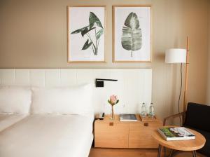 a hotel room with a bed and a table with a table sidx sidx at Hotel Arima & Spa - Small Luxury Hotels in Donostia-San Sebastián