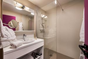 a bathroom with a sink and a shower at La Vanoise 1825 in Brides-les-Bains +15 photos