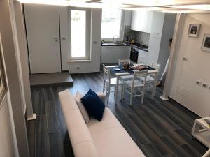 a living room with a white couch and a table at Splendido Loft al mare in Martinsicuro