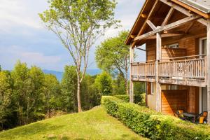 a house on a hill with a balcony at Garden & City Evian - Lugrin in Lugrin