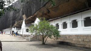 a small tree in front of a church next to a mountain at Habarana New Star Homestay in Habarana