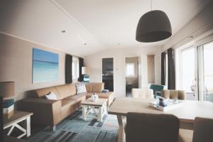 a living room with a couch and a table at Lodgepark Goitzsche GmbH in Große Mühle