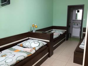 a room with two beds and a sink in it at Ubytování Lábadi in Rohatec