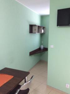 a dining room with green walls and a table and chairs at Ubytování Lábadi in Rohatec