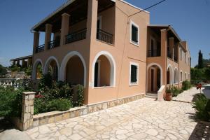 
a large white building with a large window at Fulvia Apartments in Kassiopi
