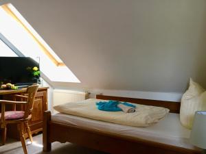 a small child laying on a bed in a room at waldhotel AUSZEIT in Tanne