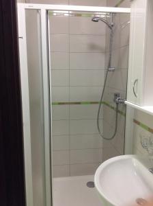 a shower with a glass door next to a sink at Ubytování Lábadi in Rohatec +12 photos