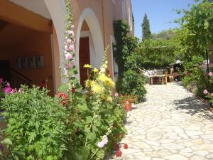 
a garden filled with lots of flowers and plants at Fulvia Apartments in Kassiopi
