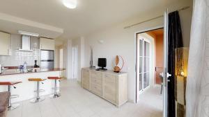 a kitchen with a counter and a tv on top of it at Casa Sofia in Costa Calma