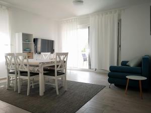 a living room with a table and a blue couch at Apartments 4you in Vir