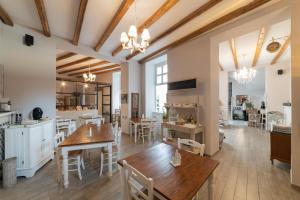 a kitchen and living room with wooden tables and chairs at Cas'E Charming House in Caserta