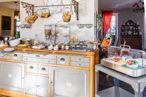 a kitchen with a counter with food on it at Le Manoir de l'antiquité in Challans