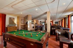 a living room with a pool table in a room at La Vanoise 1825 in Brides-les-Bains