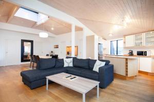 a living room with a blue couch and a table at Odinn Reykjavik Skolavordustigur Apartments in Reykjavík