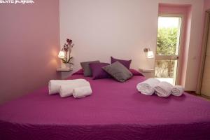 Postel nebo postele na pokoji v ubytování B&B Villa Eleonora