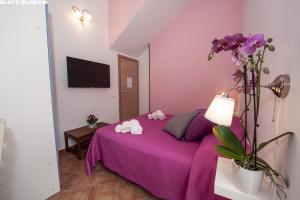 Postel nebo postele na pokoji v ubytování B&B Villa Eleonora