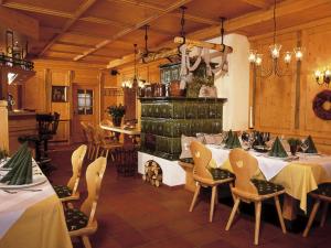 a dining room with tables and chairs and a fireplace at Landgasthof zum Scheiber in Sirnitz