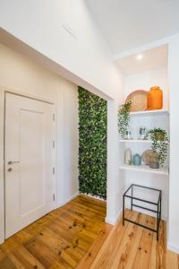 a hallway with a door and a green wall at Chiado & Design Apartment in Lisbon
