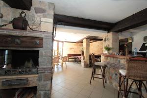a living room with a stone fireplace and a table at Villas Sozopol in Sozopol