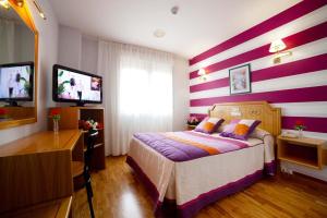 Postel nebo postele na pokoji v ubytování Hotel Río Cabia