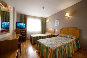 Postel nebo postele na pokoji v ubytování Hotel Río Cabia