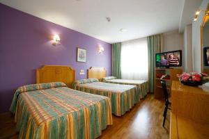 Postel nebo postele na pokoji v ubytování Hotel Río Cabia