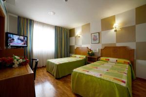 Postel nebo postele na pokoji v ubytování Hotel Río Cabia