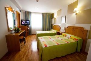 Postel nebo postele na pokoji v ubytování Hotel Río Cabia