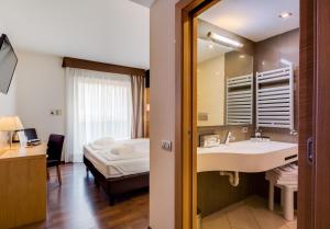 Postel nebo postele na pokoji v ubytování Best Western Hotel Adige