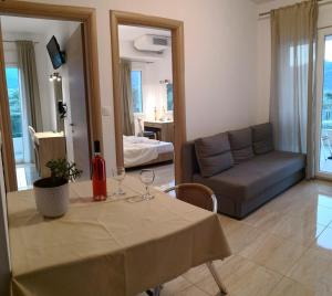 a living room with a table and a couch at Porto Thassos Apartments & Studios in Skala Potamias