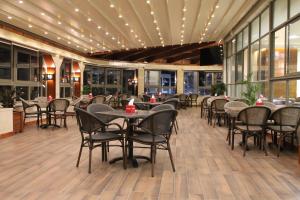 a dining room with tables and chairs in a restaurant at Mirador Hotel in Ramallah