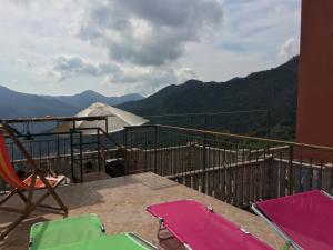 a balcony with chairs and a view of the mountains at La Casa di Zoe in Uscio
