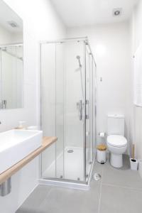 a bathroom with a shower and a sink and a toilet at Casas da Praia by Aqualeisure in Furadouro +18 photos