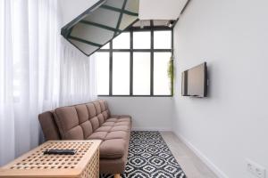 a living room with a couch and a table at Casas da Praia by Aqualeisure in Furadouro