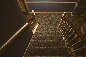 a row of stairs leading up to a staircase at The Farnham Arms Hotel in Cavan
