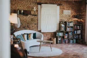 a living room with a white couch and a table at La Villa Hotel in Mombaruzzo